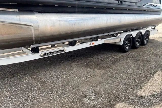 Slide: The Image of 2025 Godfrey San Pan SP2700SBW pontoon boat on a multi-axle trailer. - 39