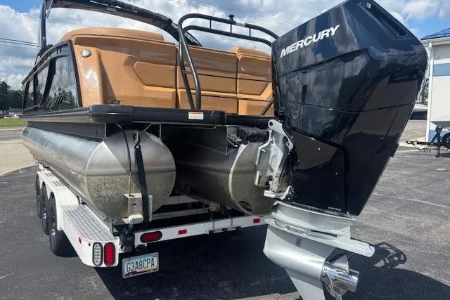 Slide: The Image of 2025 Godfrey San Pan SP2700SBW pontoon boat with Mercury outboard engine on trailer. - 4