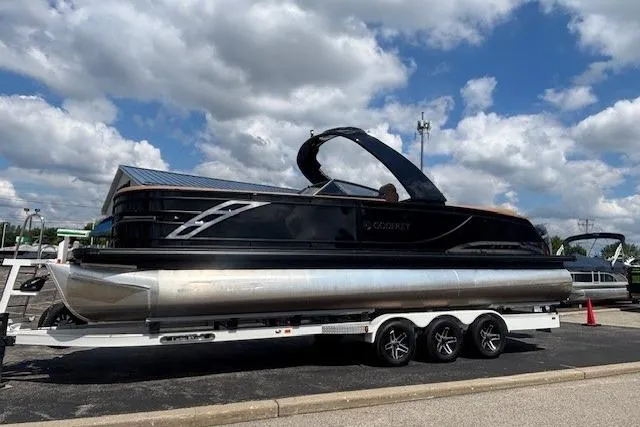Slide: The Image of 2025 Godfrey SAN PAN SP 2700 SBW pontoon boat on a trailer under a cloudy sky. - 52