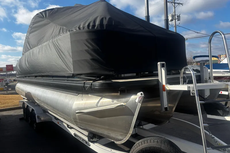 Slide: The Image of 2025 Godfrey SAN PAN SP 2700 SBW pontoon boat with cover on trailer. - 56