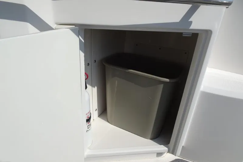 Slide: The Image of Storage compartment with trash bin on 2015 Chaparral 327 SSX boat. - 11
