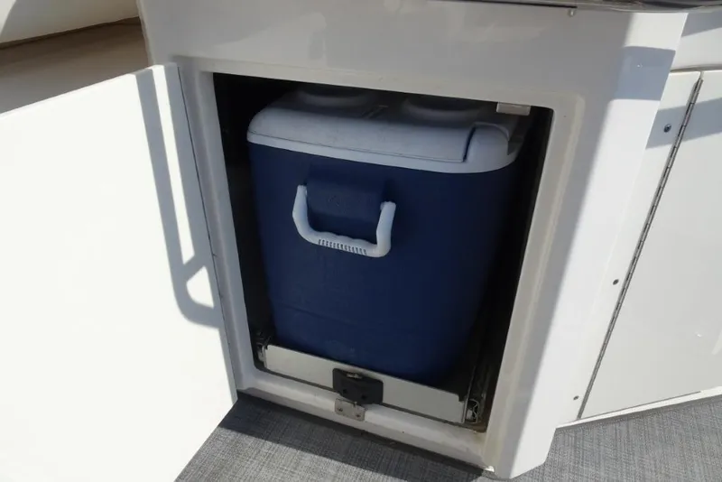 Slide: The Image of Built-in cooler storage on 2015 Chaparral 327 SSX boat. - 12