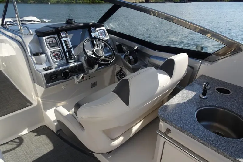 Slide: The Image of 2015 Chaparral 327 SSX boat interior with steering wheel and control panel. - 13