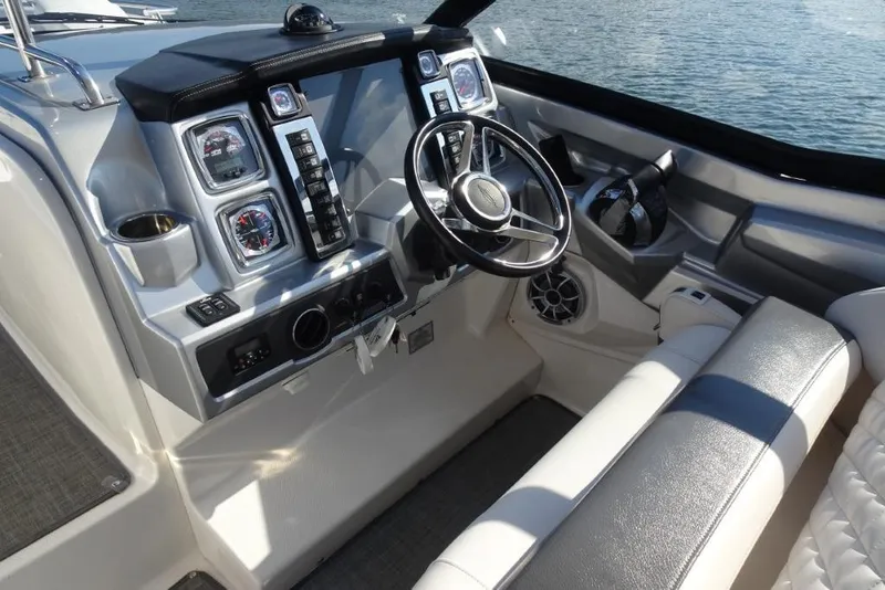 Slide: The Image of 2015 Chaparral 327 SSX boat cockpit with steering wheel and control panel. - 14