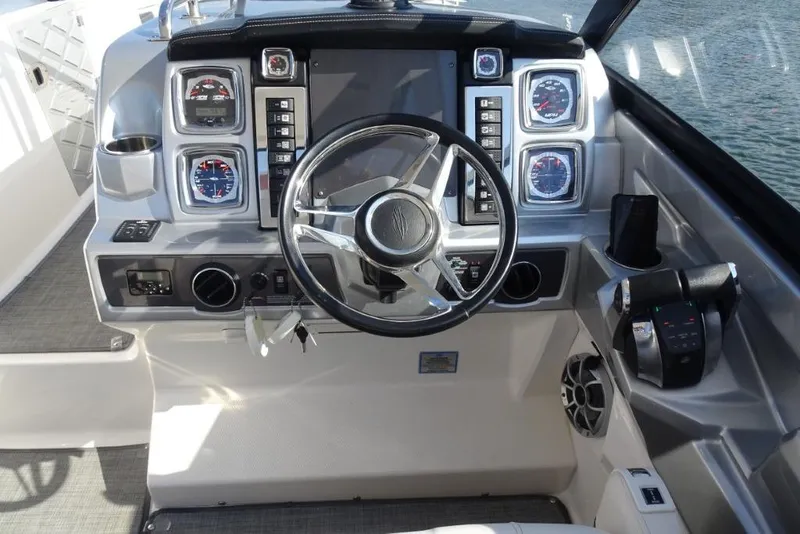 Slide: The Image of 2015 Chaparral 327 SSX boat dashboard with steering wheel and control panel. - 15