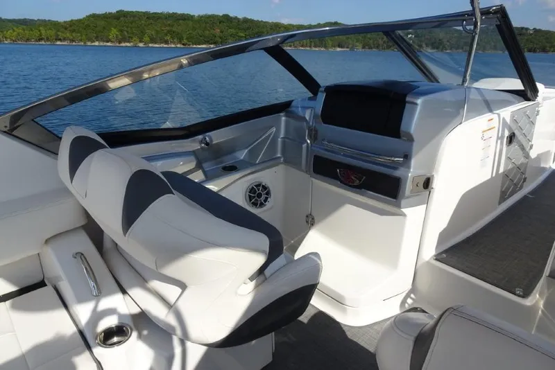 Slide: The Image of 2015 Chaparral 327 SSX boat interior with helm, seating, and lake view. - 16