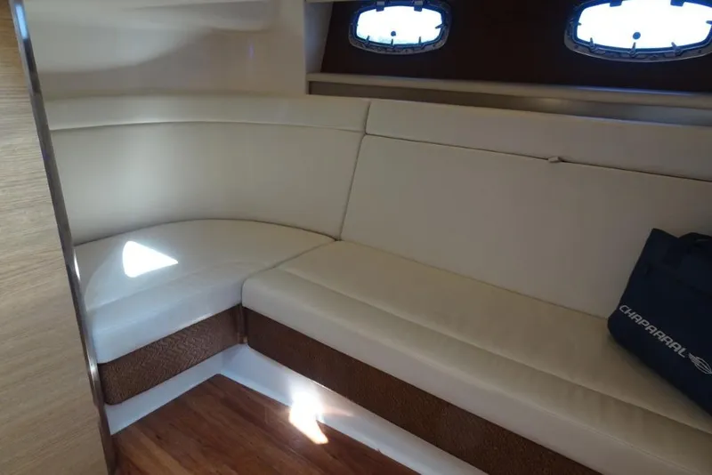 Slide: The Image of 2015 Chaparral 327 SSX interior with beige seating and wooden flooring. - 20