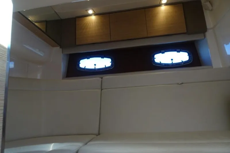 Slide: The Image of Interior cabin of 2015 Chaparral 327 SSX with modern seating and porthole windows. - 21