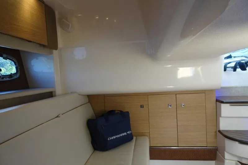 Slide: The Image of Interior of 2015 Chaparral 327 SSX boat with seating and storage cabinets. - 22