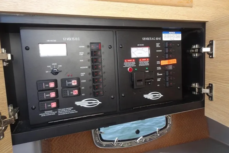Slide: The Image of Electrical panel of 2015 Chaparral 327 SSX boat, showcasing 12V and 120V systems. - 25