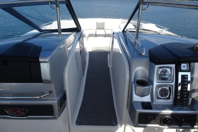 Slide: The Image of 2015 Chaparral 327 SSX boat interior with dashboard and seating area. - 26