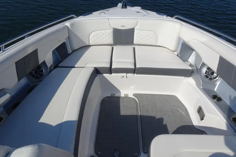 Slide: The Image of 2015 Chaparral 327 SSX boat interior with white cushioned seating and speakers. - 27