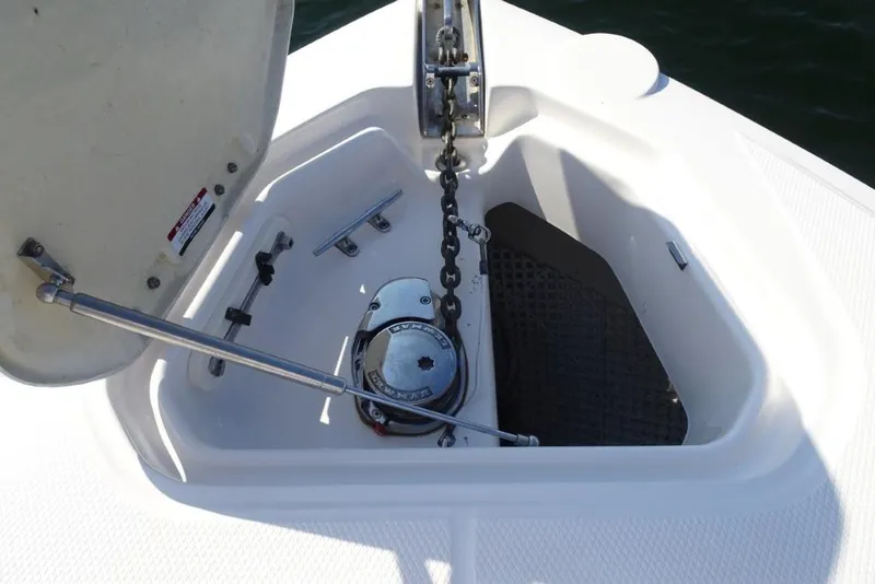 Slide: The Image of Anchor compartment of 2015 Chaparral 327 SSX boat with chain and winch. - 29