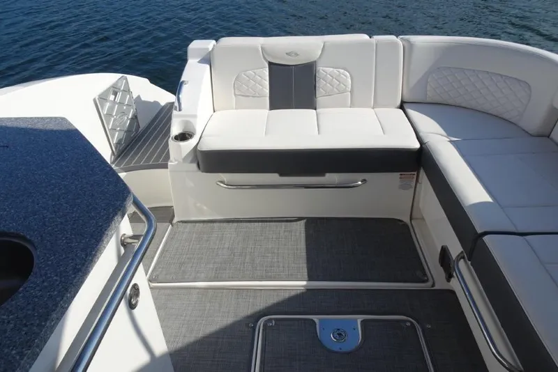 Slide: The Image of 2015 Chaparral 327 SSX boat interior with white seating and gray flooring. - 34