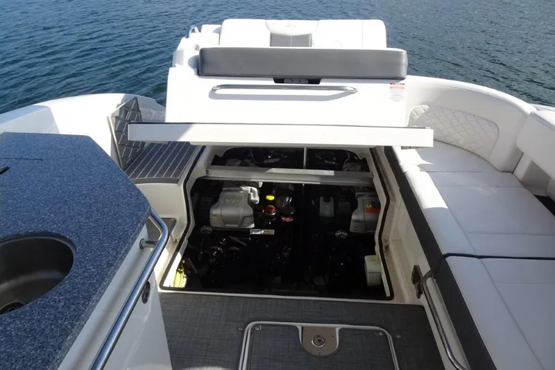 Slide: The Image of 2015 Chaparral 327 SSX boat engine compartment with open hatch, revealing interior details. - 36