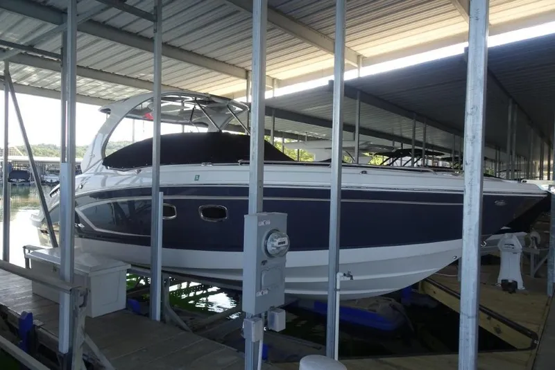 Slide: The Image of 2015 Chaparral 327 SSX boat docked in a covered marina. - 38