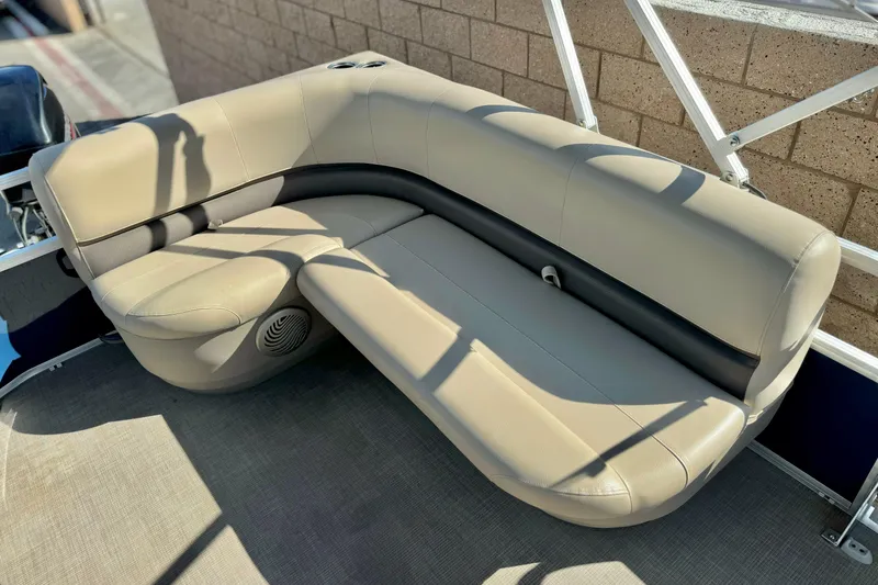 Slide: The Image of 2021 Sun Tracker Party Barge 18 DLX, beige seating with integrated speaker. - 12