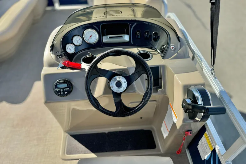Slide: The Image of 2021 Sun Tracker Party Barge 18 DLX steering console with gauges and controls. - 14