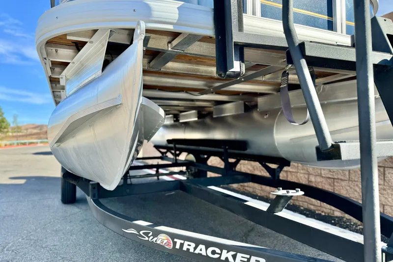 Slide: The Image of 2021 Sun Tracker Party Barge 18 DLX pontoon boat on trailer, close-up view. - 2