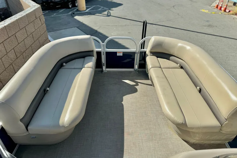 Slide: The Image of 2021 Sun Tracker Party Barge 18 DLX interior with beige seating and open deck. - 8
