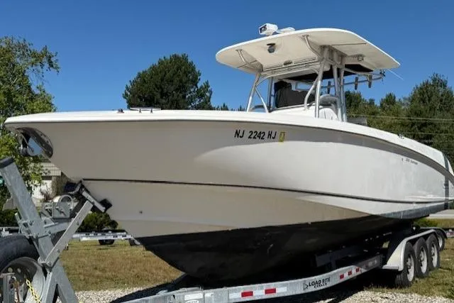 The Image of 2004 Boston Whaler 320 Outrage boat on trailer, side view, outdoors. - 0