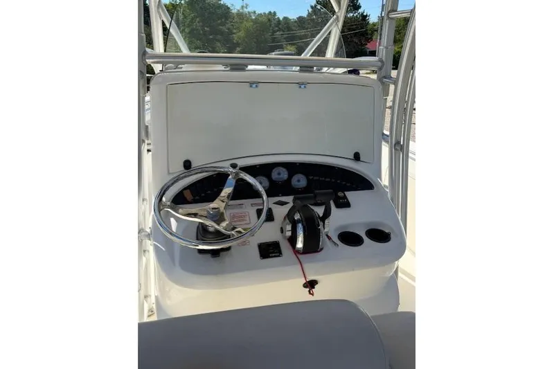 Slide: The Image of 2004 Boston Whaler 320 Outrage helm with steering wheel and control panel. - 13