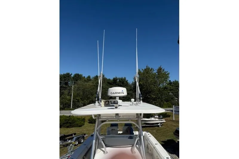 Slide: The Image of 2004 Boston Whaler 320 Outrage with Garmin radar, antennas, and clear blue sky background. - 14