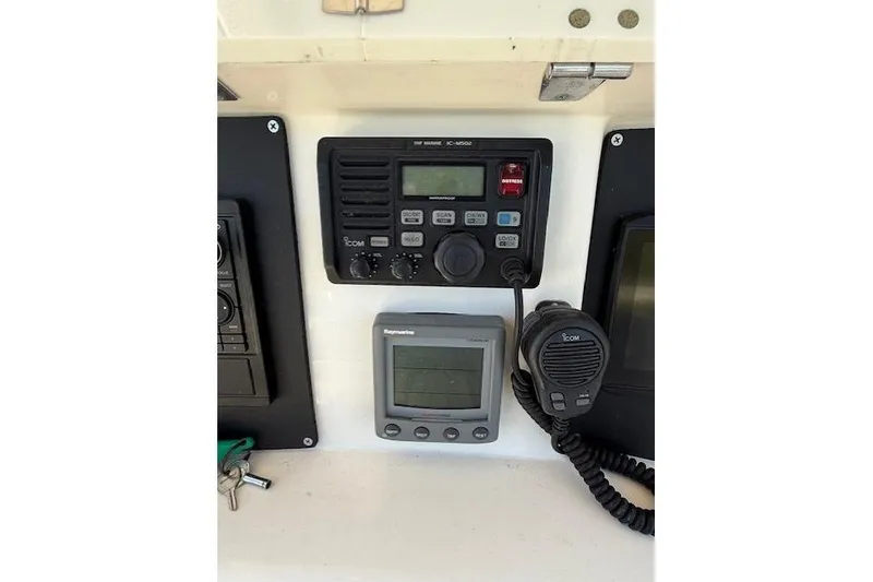 Slide: The Image of 2004 Boston Whaler 320 Outrage dashboard with marine radio and navigation equipment. - 9