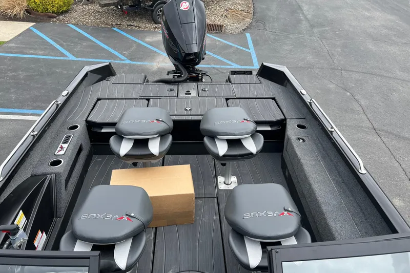 Slide: The Image of 2025 Vexus ADX190 boat interior with seating and outboard motor in parking lot. - 10