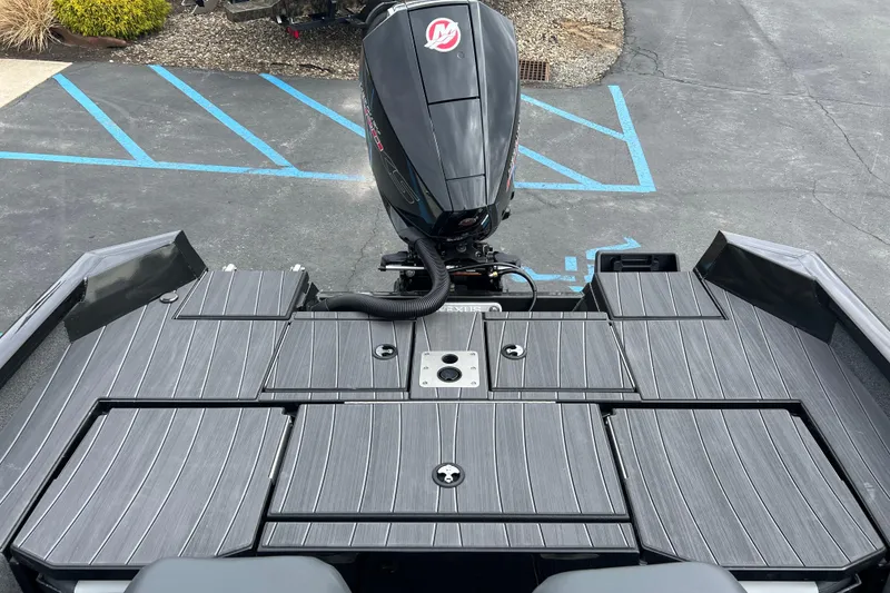 Slide: The Image of 2025 Vexus ADX190 boat with sleek deck design and powerful outboard motor. - 13