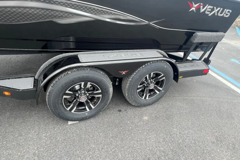 Slide: The Image of 2025 Vexus ADX190 trailer with dual black alloy wheels and sleek design. - 2