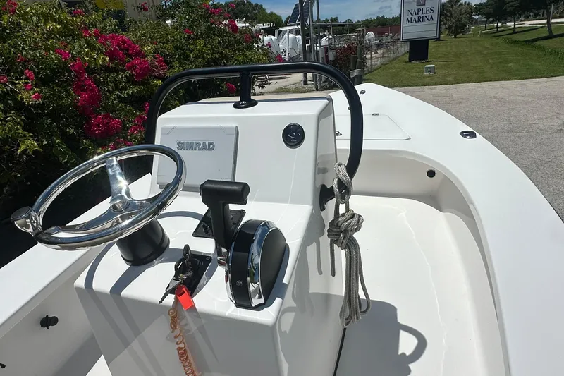 Slide: The Image of 2024 Delta Boatworks Delta 18 console with steering wheel and controls at Naples Marina. - 3