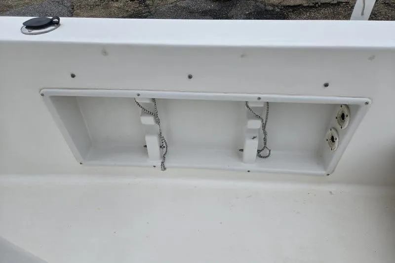 Slide: The Image of 2007 Sea Hunt Triton 220 boat interior compartment with chains and sockets. - 11