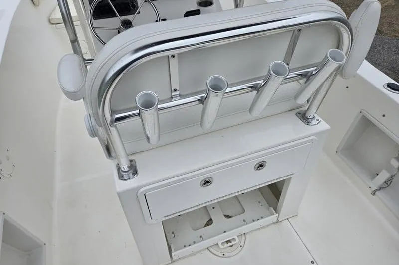 Slide: The Image of 2007 Sea Hunt Triton 220 boat interior with rod holders and storage compartment. - 12