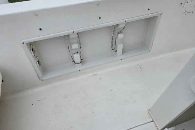 Slide: The Image of 2007 Sea Hunt Triton 220 boat interior, featuring storage compartment and clean white deck. - 13