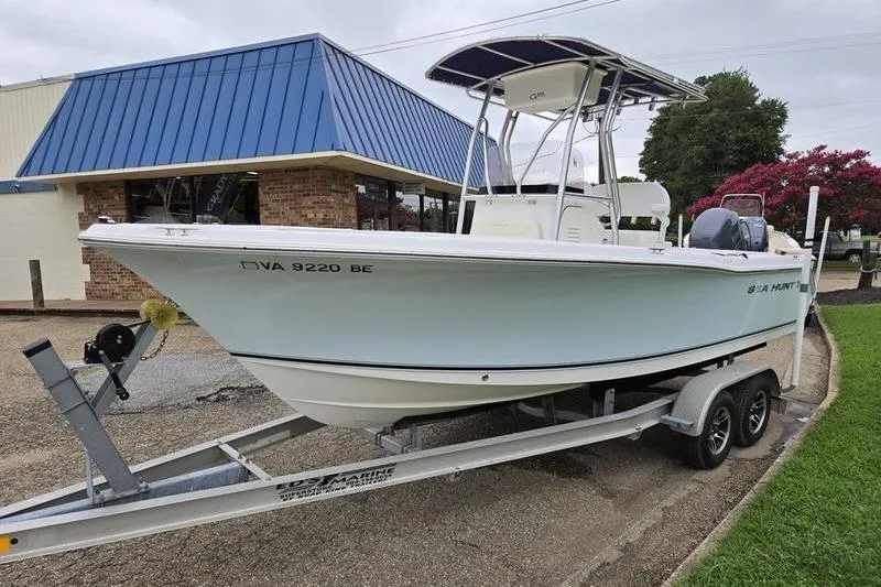Slide: The Image of 2007 Sea Hunt Triton 220 boat on trailer, parked near a building. - 3