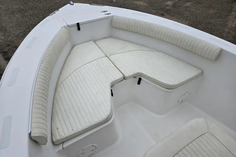 Slide: The Image of 2007 Sea Hunt Triton 220 boat interior with white cushioned seating. - 4