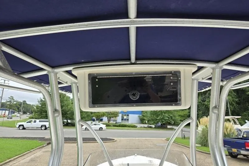 Slide: The Image of T-top view of 2007 Sea Hunt Triton 220 boat with blue canvas cover. - 9