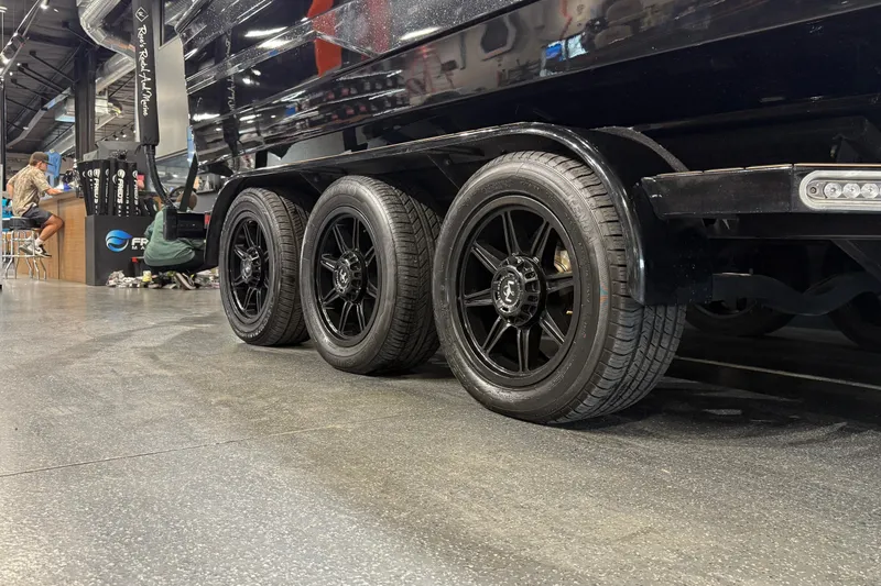 Slide: The Image of 2021 Centurion Ri265 trailer with black wheels in showroom setting. - 10