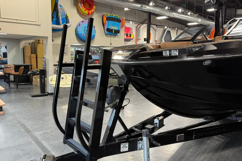 Slide: The Image of 2021 Centurion Ri265 boat displayed indoors with water sports equipment. - 12