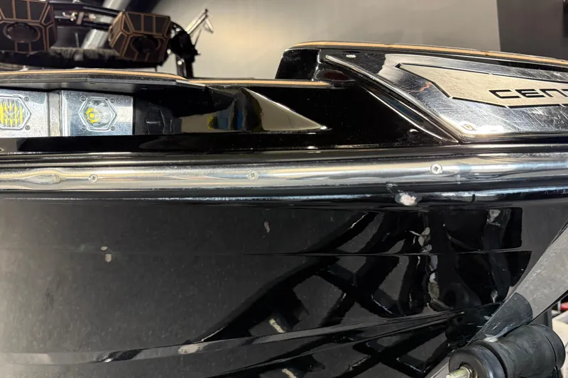 Slide: The Image of 2021 Centurion Ri265 boat close-up, showcasing sleek black exterior and modern design elements. - 13