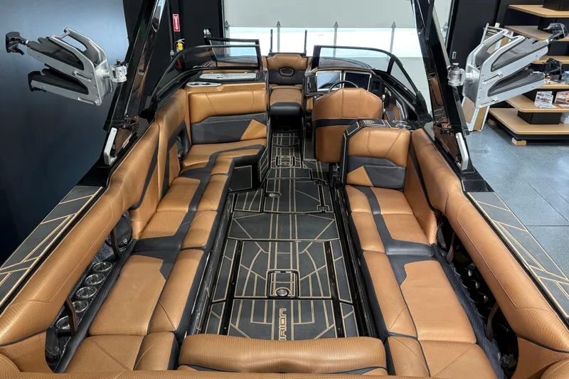 Slide: The Image of 2021 Centurion Ri265 boat interior with luxurious brown seating and sleek design. - 14