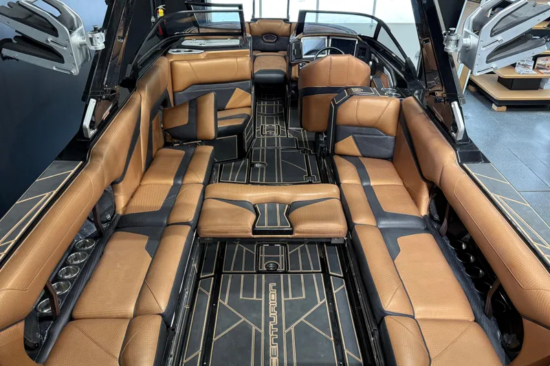 Slide: The Image of Luxurious interior of 2021 Centurion Ri265 boat with brown and black seating. - 15