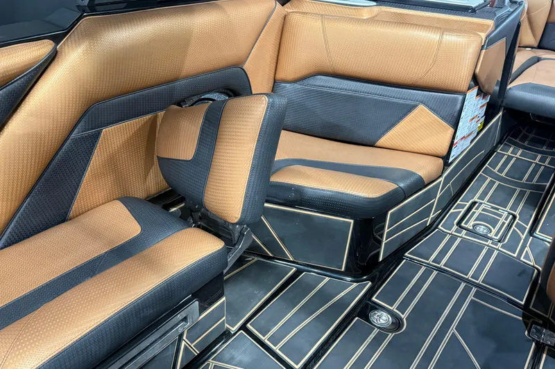 Slide: The Image of 2021 Centurion Ri265 interior with luxurious brown and black seating and stylish flooring. - 16