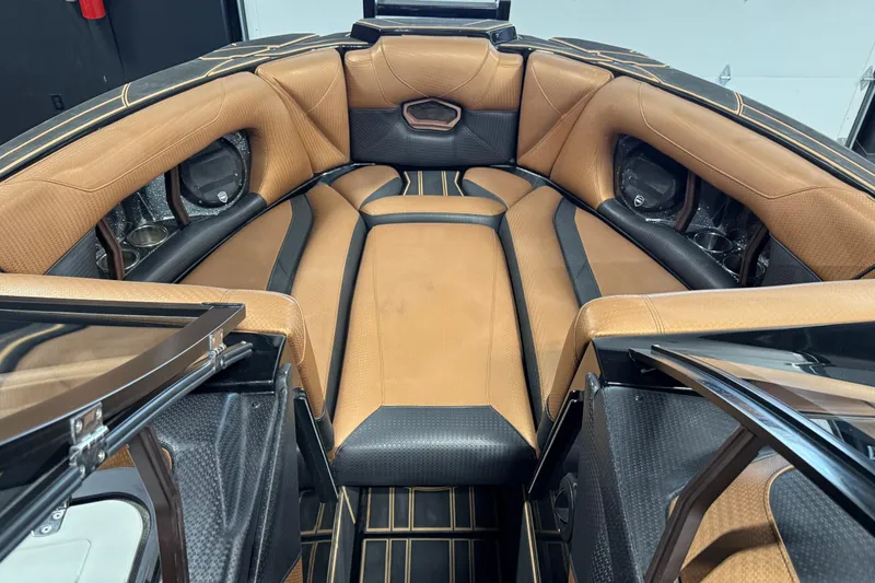 Slide: The Image of Luxurious interior of 2021 Centurion Ri265 boat with tan and black seating. - 18