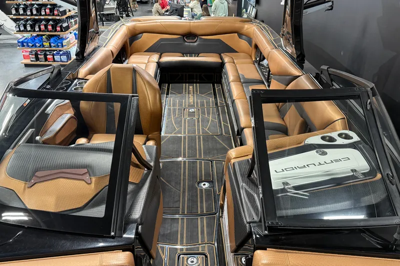 Slide: The Image of 2021 Centurion Ri265 boat interior with luxurious brown seating and modern design. - 19