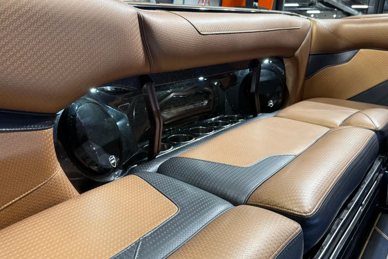 Slide: The Image of Luxurious brown and black leather interior of 2021 Centurion Ri265 boat with built-in speakers. - 21