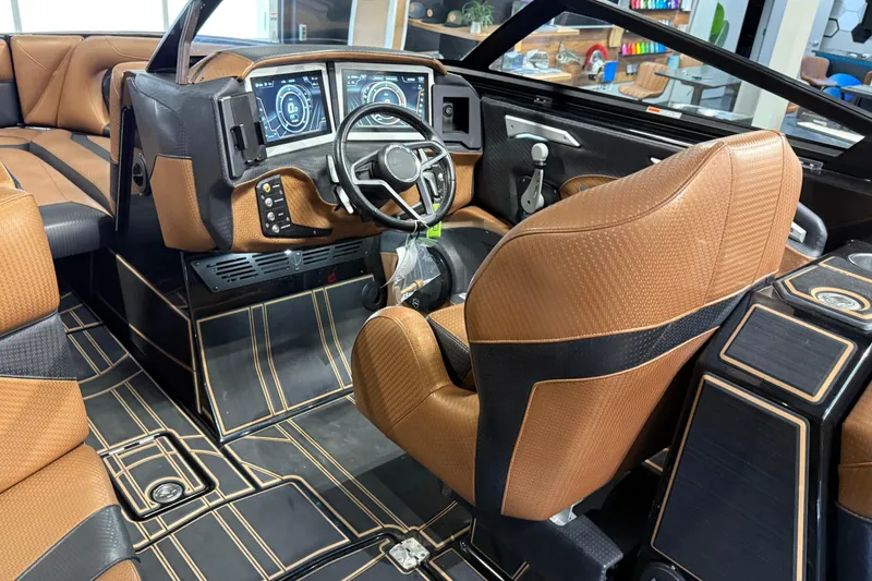 Slide: The Image of 2021 Centurion Ri265 boat interior with brown leather seats and modern dashboard. - 23