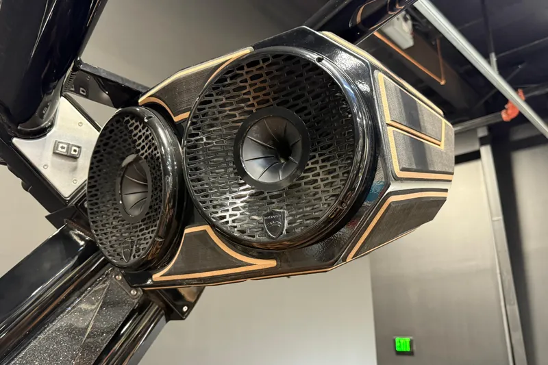 Slide: The Image of Close-up of 2021 Centurion Ri265 boat speakers with sleek black and gold design. - 26