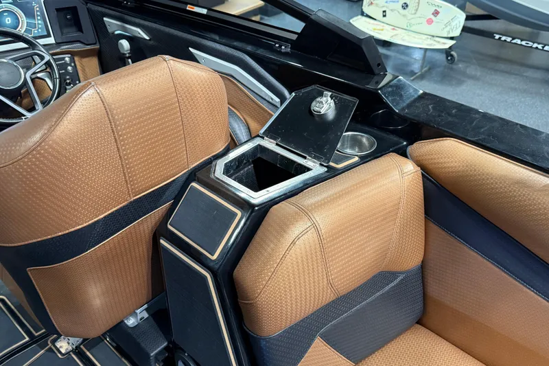 Slide: The Image of 2021 Centurion Ri265 interior with brown seats and open storage compartment. - 28